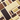 An assortment of variously shaped chocolate bars, including dark, milk, and white chocolate, arranged in a neat, geometric pattern on a light beige surface.