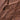 Close-up of a textured chocolate surface with visible almond or nut pieces embedded throughout, showing smooth, sharp, and jagged lines on the surface.