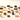 An assortment of colorful, variously shaped gourmet chocolates and candies are arranged on a light surface, including pieces with layers, coatings, and different textures.