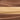 Close-up of creamy spreads in horizontal layers, featuring milk chocolate brown, dark chocolate brown, and a light beige layer resembling peanut butter or white chocolate, all with a smooth, glossy texture.