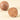 A whole Cream & Crunchy Nougatine sphere beside a halved piece, revealing a decadent hazelnut cream and nougatine heart. - AI generated text