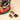 A medium-sized, round Vintage Dream Hamper filled with assorted chocolates, presented with three fine, unwrapped pieces. - AI generated text