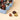 A light blue Vintage Dream Pine tin, medium size, elegantly displayed with three unwrapped, artisanal chocolates. - AI generated text