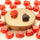 An elegant arrangement of 75% Extra Dark Chocolate Hearts scattered around a gold pedestal displaying two signature hearts. - AI generated text